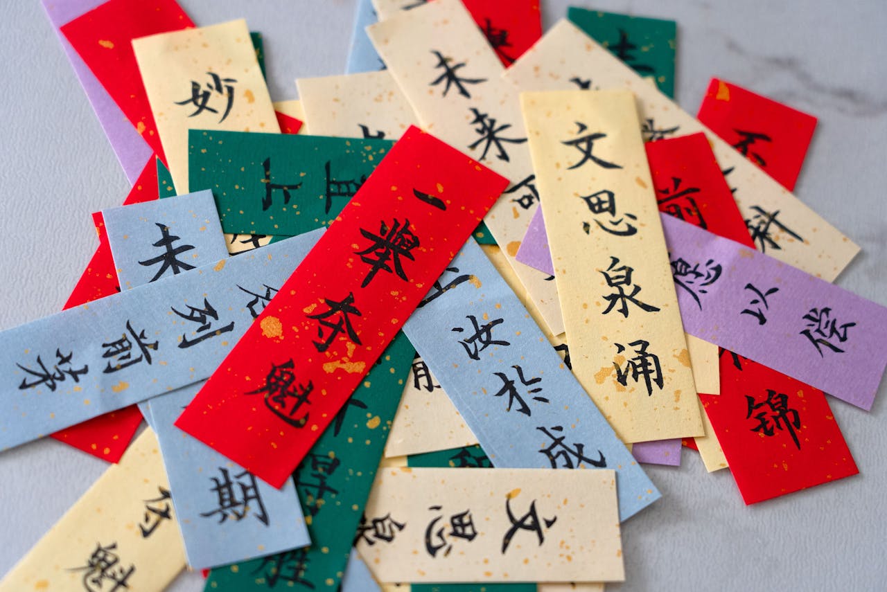 Vibrant paper cards featuring Chinese calligraphy in various colors and fonts.